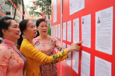 Người dân xem danh sách các ứng cử viên tại khu vực bỏ phiếu số 1, phường Xuân Hòa, TP. Hồ Chí Minh. Ảnh: Thanh Vũ – TTXVN