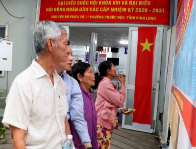Cử tri tìm hiểu tiểu sử các ứng cử viên tại khu vực bỏ phiếu số 11 (Bệnh viện Đa khoa tỉnh Vĩnh Long - phường Phước Hậu, tỉnh Vĩnh Long). Ảnh: Lê Thúy Hằng - TTXVN. 